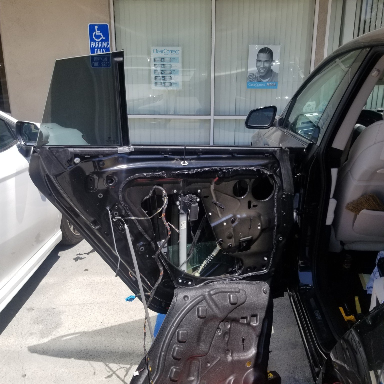 Open vehicle door during power window repair